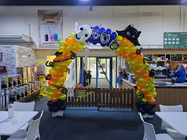 Halloween themed balloon arch with ghosts, bats and BOO letters