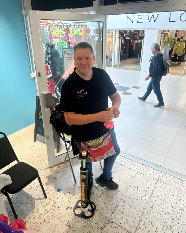 Mista Twister standing with balloon equipment in a shopping center